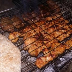 a bunch of food is cooking on a grill at The Garden Under The Moon in Al Ḩayz