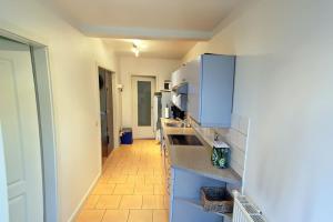 a kitchen with blue cabinets and a counter top at Ruhetal in Tinnum