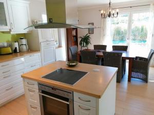 a kitchen with a sink and a table with chairs at Stadthaus Lübsche Burg - ABC326 in Wismar