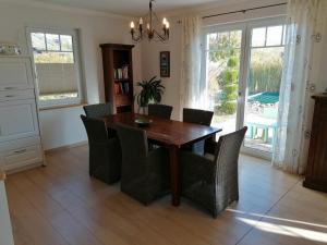 a dining room with a wooden table and chairs at Stadthaus Lübsche Burg - ABC326 in Wismar