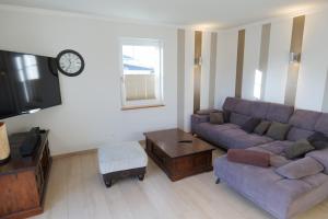 a living room with a couch and a tv at Stadthaus Lübsche Burg - ABC326 in Wismar +34 photos