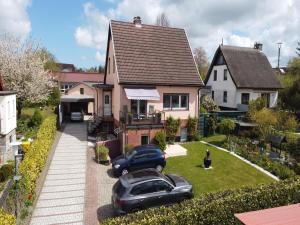 a house with two cars parked in the yard at Romantischer Rückzugsort in Kröpelin in Strandnähe in Kröpelin