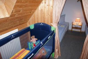 a childs bedroom with a bunk bed with a toy at Ferienhaus Albrecht - ABC207 in Wismar +2 photos