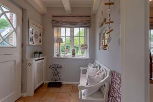 a baby room with a white crib and a window at Hüs Leen in Hedehusum