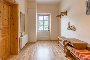 a room with a wooden table and a door at Ferienhaus Klütz in Klütz +10 photos