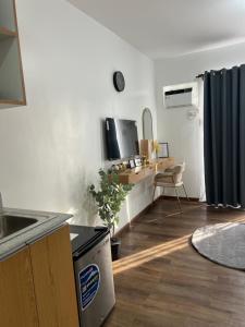 a kitchen with a sink and a desk in a room at JeMeCa Suites in Kauswagan