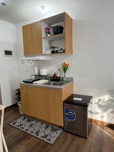a small kitchen with a sink and a stove at JeMeCa Suites in Kauswagan