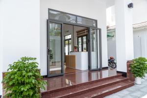 a glass door on a building with a motorcycle inside at HomyPlus Apartment in Ho Chi Minh City