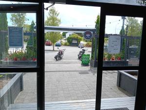 a view of a parking lot through a window at Three Furlongs Bar-Grill-Hotel in Kaiwaka