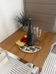 a table with a bottle of wine and glasses on it at Frangipani Studio PET FRIENDLY!!! in Ulladulla +30 photos