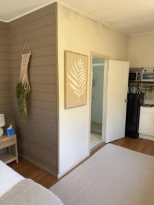a bedroom with a door leading to a kitchen at Frangipani Studio PET FRIENDLY!!! in Ulladulla