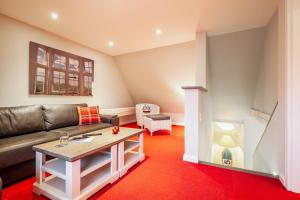 a living room with a couch and a coffee table at FöhrEuch 2 in Borgsum