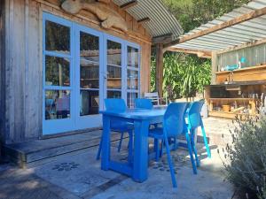 a blue table and chairs on a patio at Delightful Dolphin 'Lodge' in Akaroa