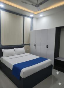 a bedroom with a bed with blue and white sheets at Full villa welcome for you in Jaipur