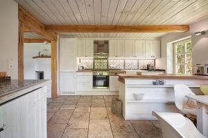 een keuken met witte kasten en een aanrechtblad bij Haus Augenblick in Utersum