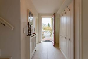 a hallway with a door leading to a yard at Landhaus Meta in Wrixum