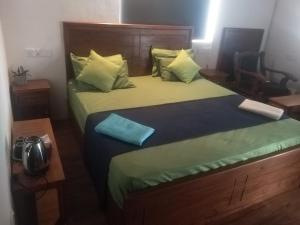 a bedroom with a large bed with a blue pillow at Solace Transit Villa in Katunayaka +25 photos