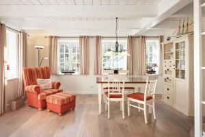 een eetkamer met een tafel en een stoel bij Reethüs Marta - rechts in Utersum