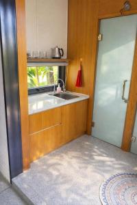 a kitchen with a sink and a window at Đất Quảng Villa in An Tân