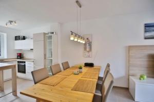 a dining room with a wooden table and chairs at City Marina, CM20a in Cuxhaven