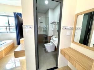 a bathroom with a toilet and a glass shower at Khách Sạn Ba Đoàn 1 in Con Dao +35 photos
