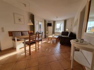 a living room with a table and a couch at Ferienhaus Sommerwiese - ABC327 in Klein Warin