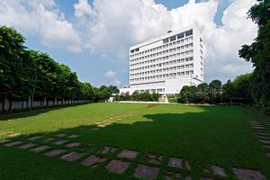 a large building in front of a green field at Clarks Avadh in Lucknow