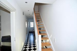 a staircase in a house with a checkered floor at Fischers Fritz - Brückstr 32 in Heiligenhafen