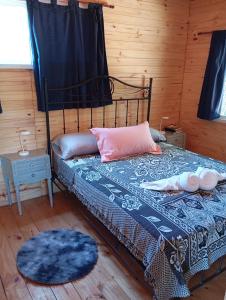 a bedroom with a bed with a blue blanket and pillows at Cabañas Campos del Parana in San Pedro +48 photos