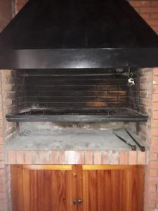 a brick oven with a stove top with snow on it at Departamento en barrio tranquilo in Mar del Plata