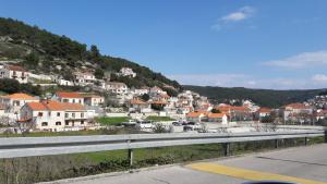 a view of a town with houses and a road at Apartments Nikola in Pučišća
