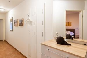 a bedroom with white walls and a large mirror at Stranddüne, D13 in Duhnen