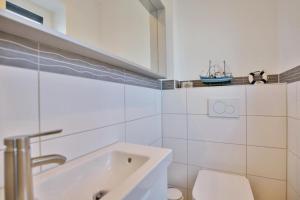 a bathroom with a tub and a toilet and a sink at City Marina, CM24d in Cuxhaven