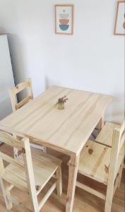 a wooden table and chairs with a plant on it at Pasos del Dique in Cortaderas