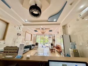 a office with a desk and a living room at Khách Sạn Ba Đoàn 1 in Con Dao