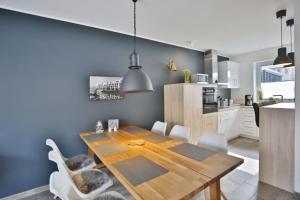 a kitchen and dining room with a wooden table and chairs at City Marina, CM20b in Cuxhaven