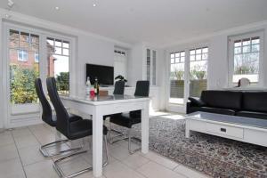 a living room with a table and chairs and a couch at Maybachstraße 22 in Westerland