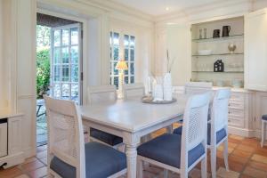 a dining room with a wooden table and chairs at Ferienhaus Hideaway in Kampen