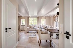 a living room with a couch and a table at Reethaus Friesenjung in Hedehusum +22 photos