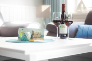 two glasses of red wine and a box on a table at Amoy - Werftstraße 2 in Heiligenhafen