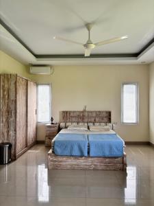 a bedroom with a bed and a ceiling fan at Private Studio Near Kedungu Beach Cozy & Affordable in Tanah Lot