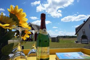 a bottle of wine sitting on a table with glasses at Reethaus "Melsa" in Zierow +12 photos