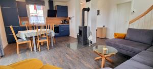 a living room with a couch and a table with a fireplace at Reethaus "Melsa" in Zierow