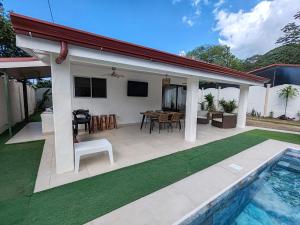 a patio with a table and chairs and a pool at Casa Tribu in Agujas