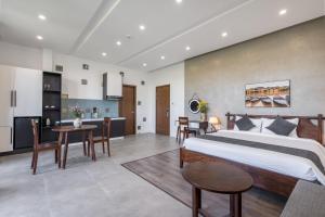 ein Schlafzimmer mit einem großen Bett und eine Küche in der Unterkunft Anchie Retreat Villa Hội An in An Bàn (2)
