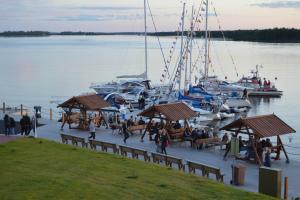 a group of people walking on a dock with boats at Toranda Merilinna in Tornio