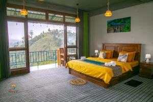 a bedroom with a bed and a large window at Ella T&D Resort in Ella +91 photos