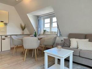 a living room with a couch and a table at Sinfonie, Whg 5 in Tinnum