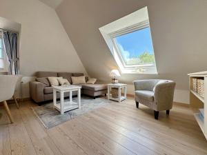 a living room with a couch and a window at Sinfonie, Whg 5 in Tinnum
