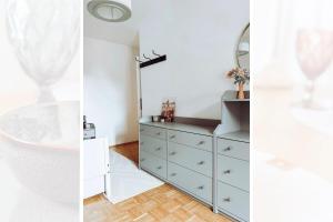 a white bathroom with a dresser and a mirror at Niedere Burgstraße - im Herzen der Altstadt in Pirna